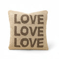 Pillow with 'LOVE' text on a beige background