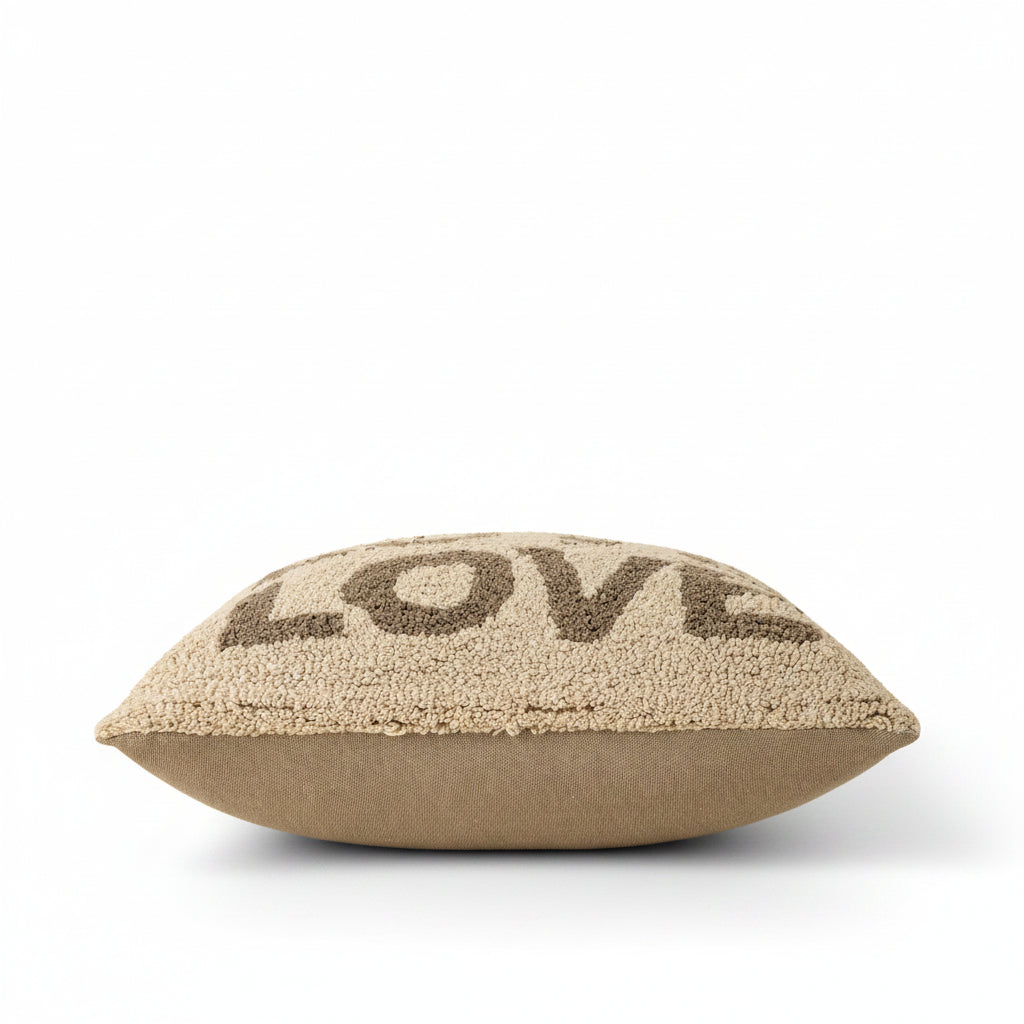 Textured pillow with 'LOVE' on a beige background