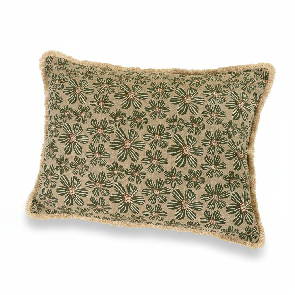 A rectangular decorative throw pillow with a beige background and an all-over green floral pattern, finished with a fringed edge, shown against a solid light beige background.