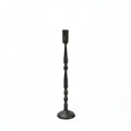 Black candlestick holder on a beige background