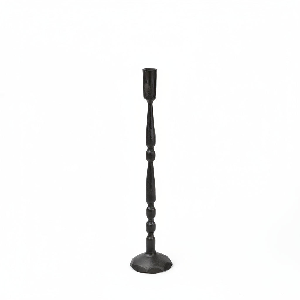 Black candlestick holder on a beige background
