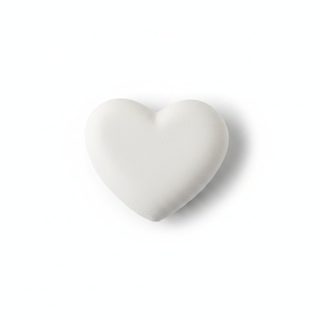 Heart-shaped stone on a beige background
