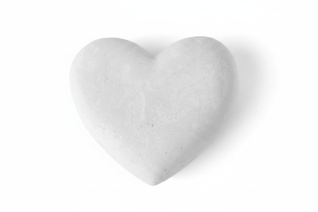 Heart-shaped stone on a beige background