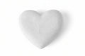 Heart-shaped stone on a beige background