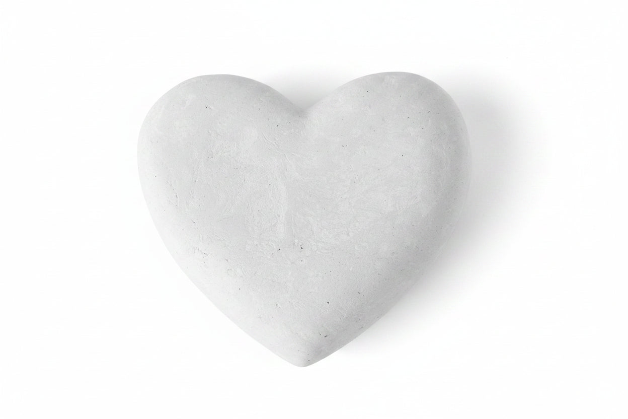 Heart-shaped stone on a beige background